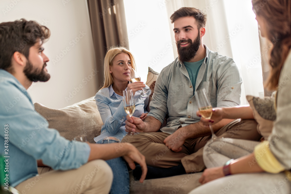 Friends toasting in living room Friends toasting in living room