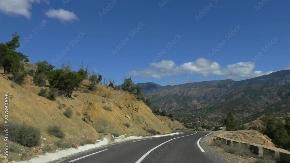 Car windshield view traveling travelling winding downhill P1001 road in Morocco, Africa Car windshield view traveling travelling winding downhill P1001 road in Morocco, Africa