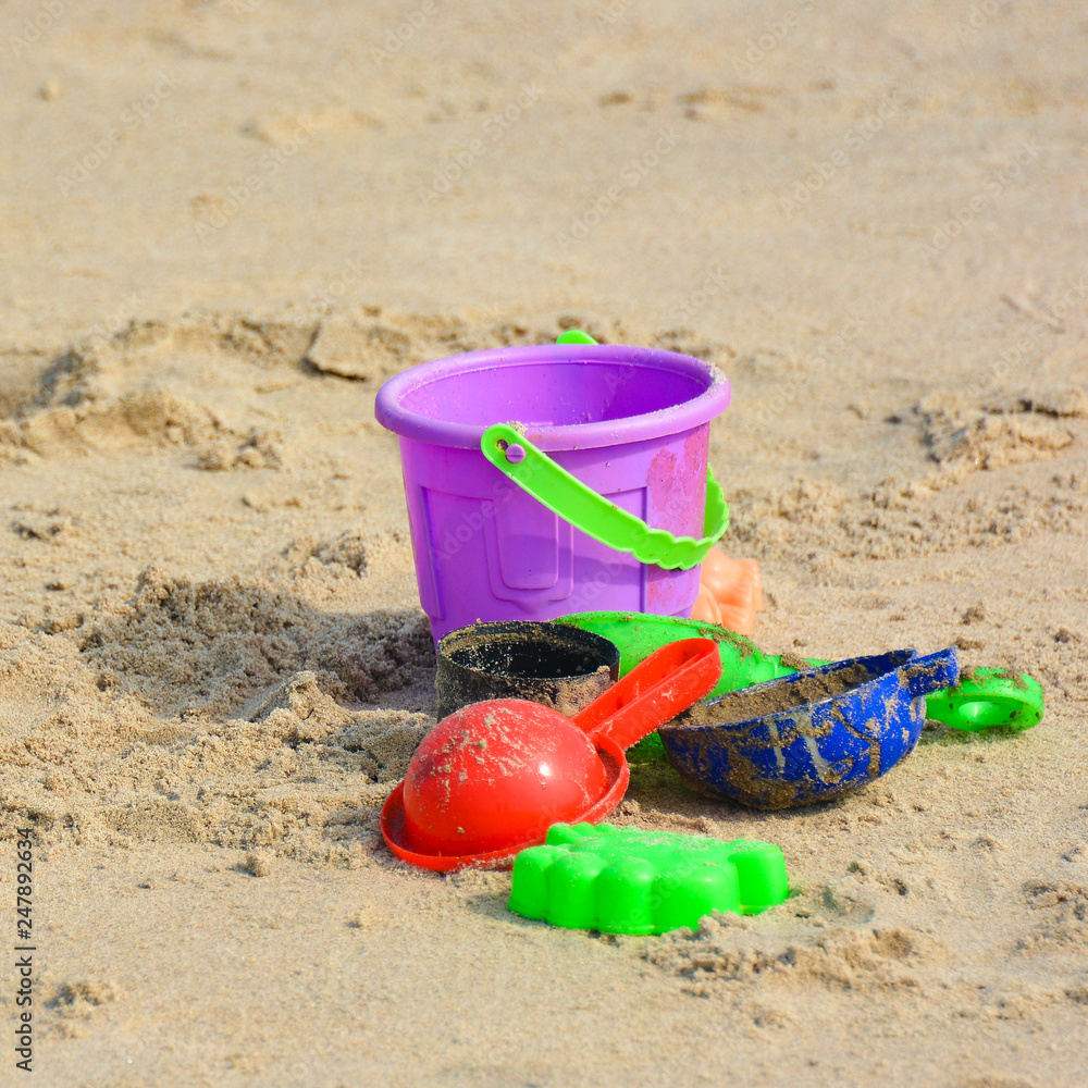 Children's toys on the sea sand on the beach of North Goa.India Children's toys on the sea sand on the beach of North Goa.India