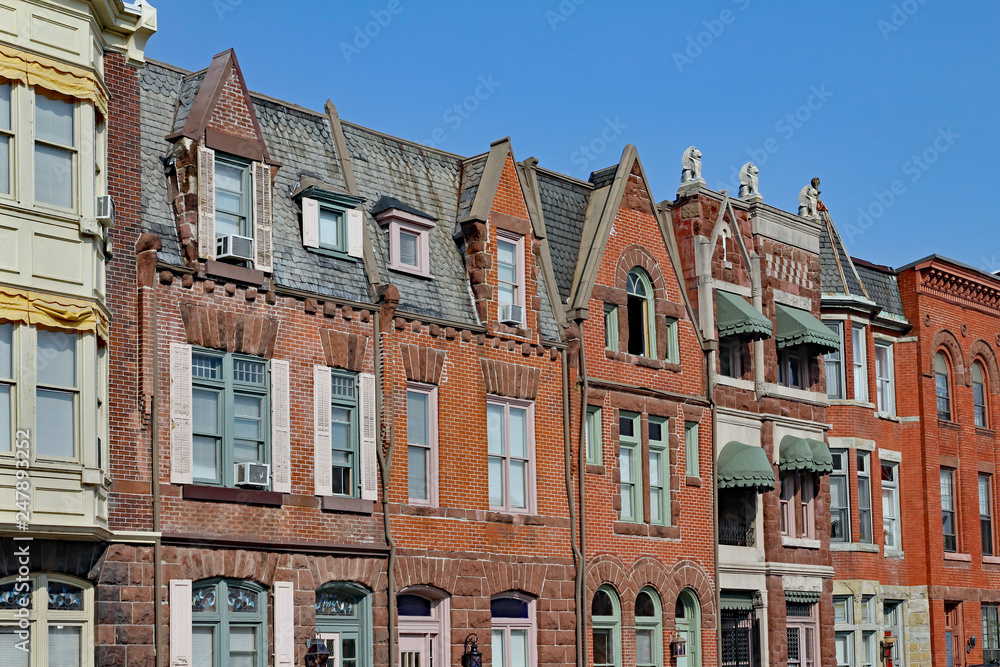 row of old townhouses with gables and brownstone trim row of old townhouses with gables and brownstone trim