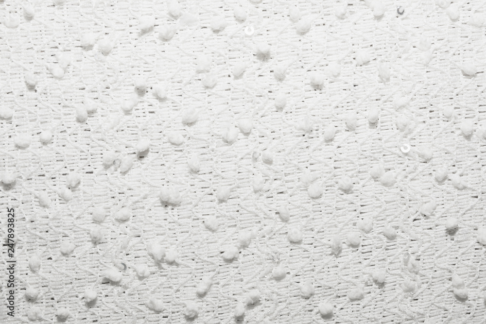 Obraz premium The texture of the knitted white fabric for the background 