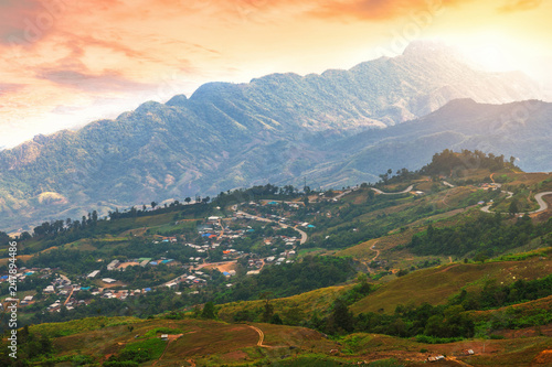 Sunset of Panoramic view mountain range with village on Nature Trail in Phu Thap Buek National Park in Phetchabun, Thailand.