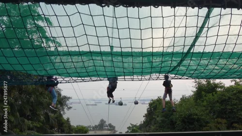 3 People on Zipline Slowmotion, In Forest, Beach, Sea photo