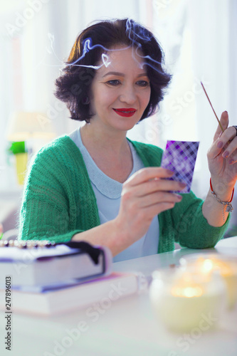 Positive nice woman looking at the card