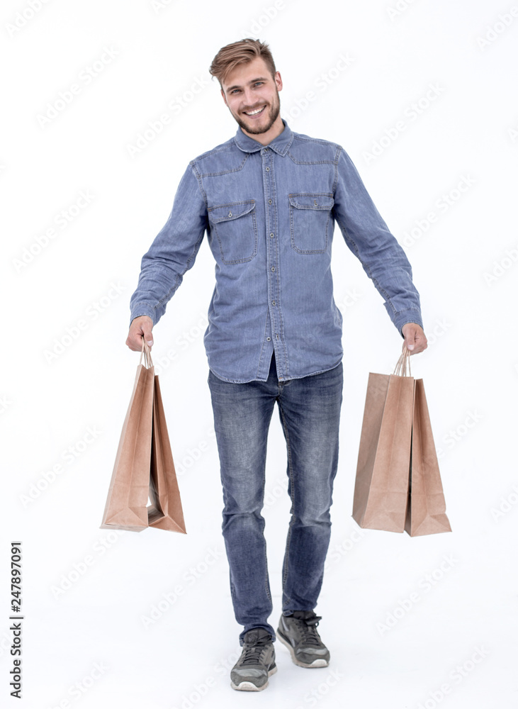 a young guy with brown paper bags in his hands. a young guy with brown paper bags in his hands.