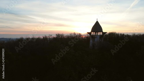 Aerial Zoom Out Of A Viewpoint On A Hill With Sunrise in The Background photo