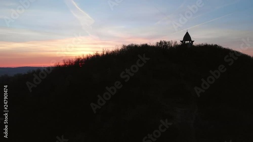 Aerial Zoom Out of a Viewpoint On A Hill With Sunrise in The Background photo