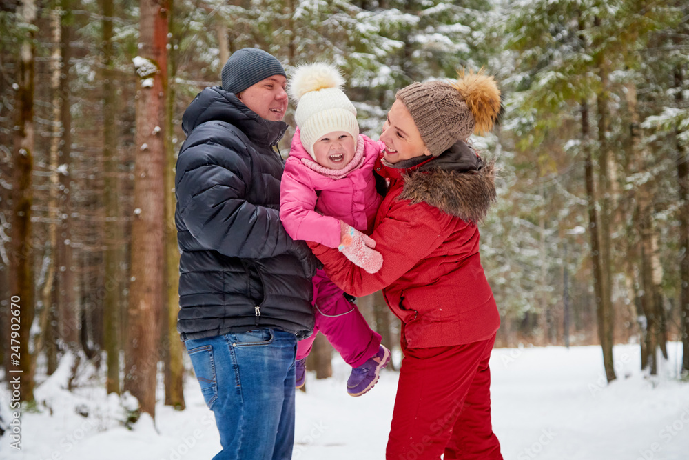 Ordinary family walking in a winter forest