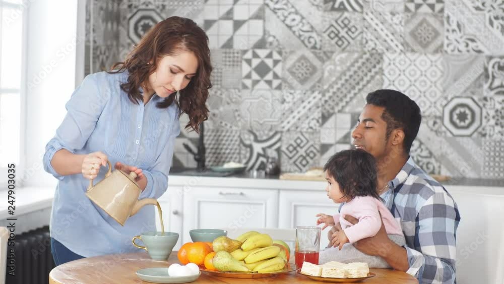 Happy family having breakfast together in the morning at home in the kitchen. Happy family having breakfast together in the morning at home in the kitchen.