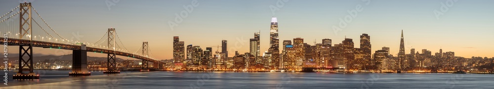 The Bay Bridge and San Francisco Skyline Panorama. Views from Yerba Buena Island on a clear winter evening..