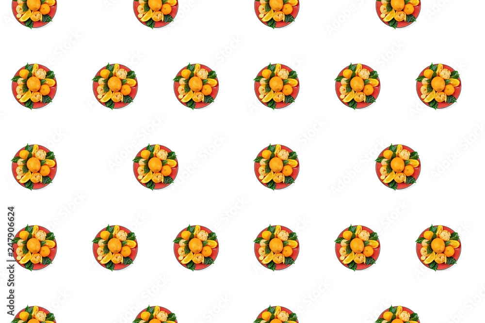 Red plate of oranges and tangerines with green leaves on a light background Top view copy space pattern Red plate of oranges and tangerines with green leaves on a light background Top view copy space pattern