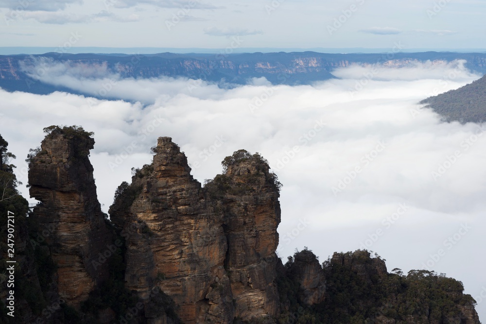Three sisters blue mountains admist fog and clouds