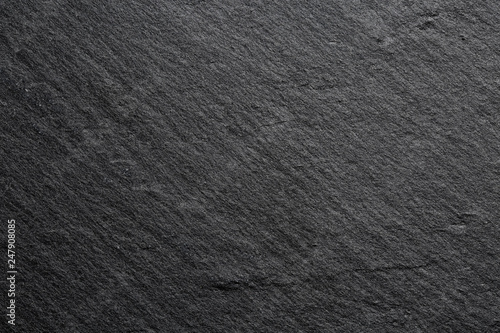 Extreme close up of the texture of a dark stone kitchen board