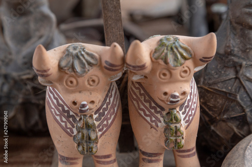 The Pucara bulls are placed on the roofs of houses. Crafts, Peru