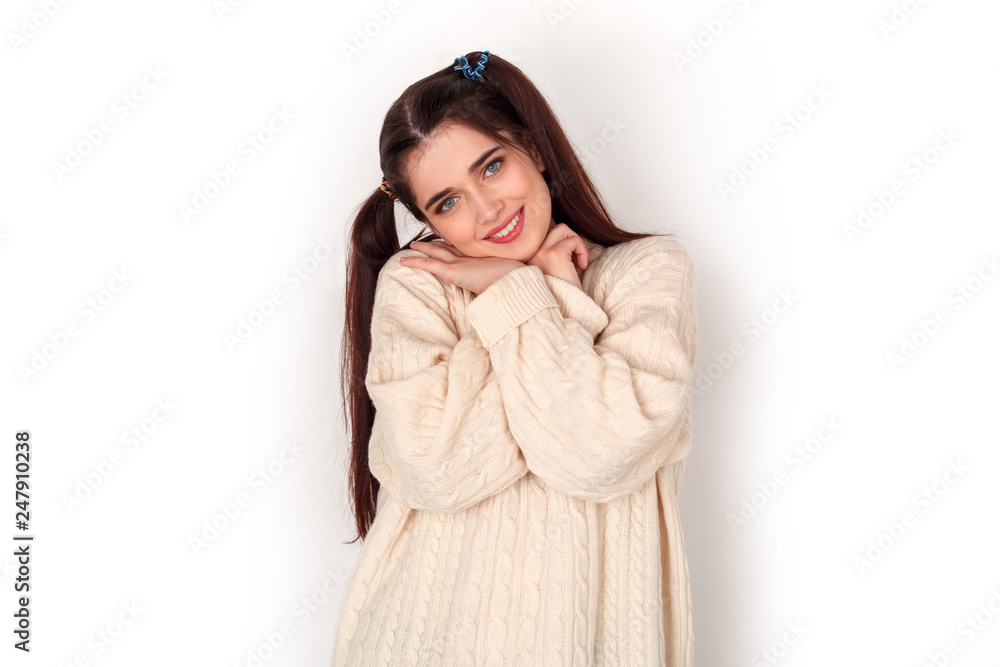 Young girl with two ponytails studio standing isolated on white hugging herself looking camera cute Young girl with two ponytails studio standing isolated on white hugging herself looking camera cute