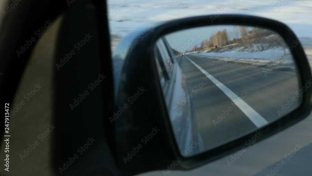mountainous landscape reflection in the side rearview mirror of the car. winter season. slow motion mountainous landscape reflection in the side rearview mirror of the car. winter season. slow motion