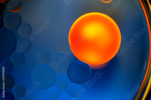 big yellow orange ball on blue background with circles
