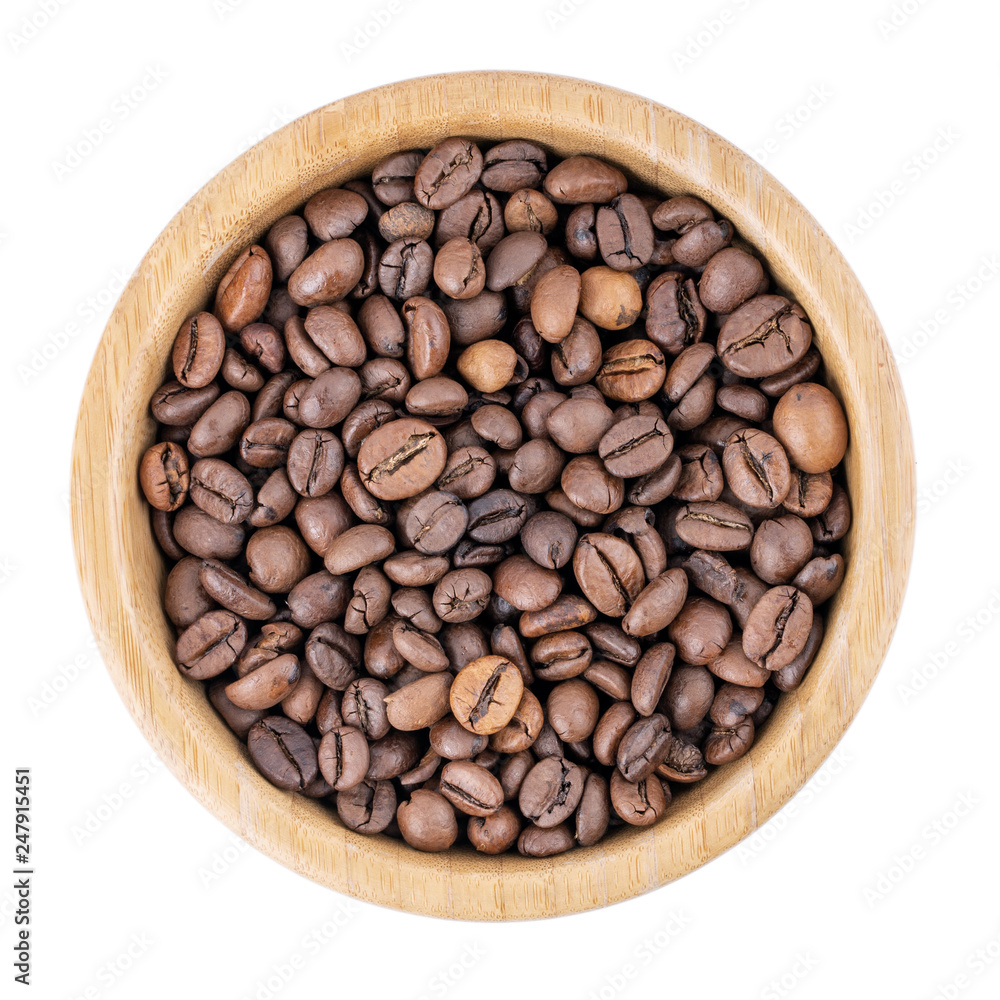 Fototapeta premium Coffee beans in wooden bowl isolated on white. Top view.