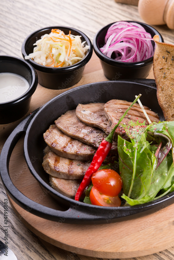 Fired beef tongue served with chili pepper Fired beef tongue served with chili pepper