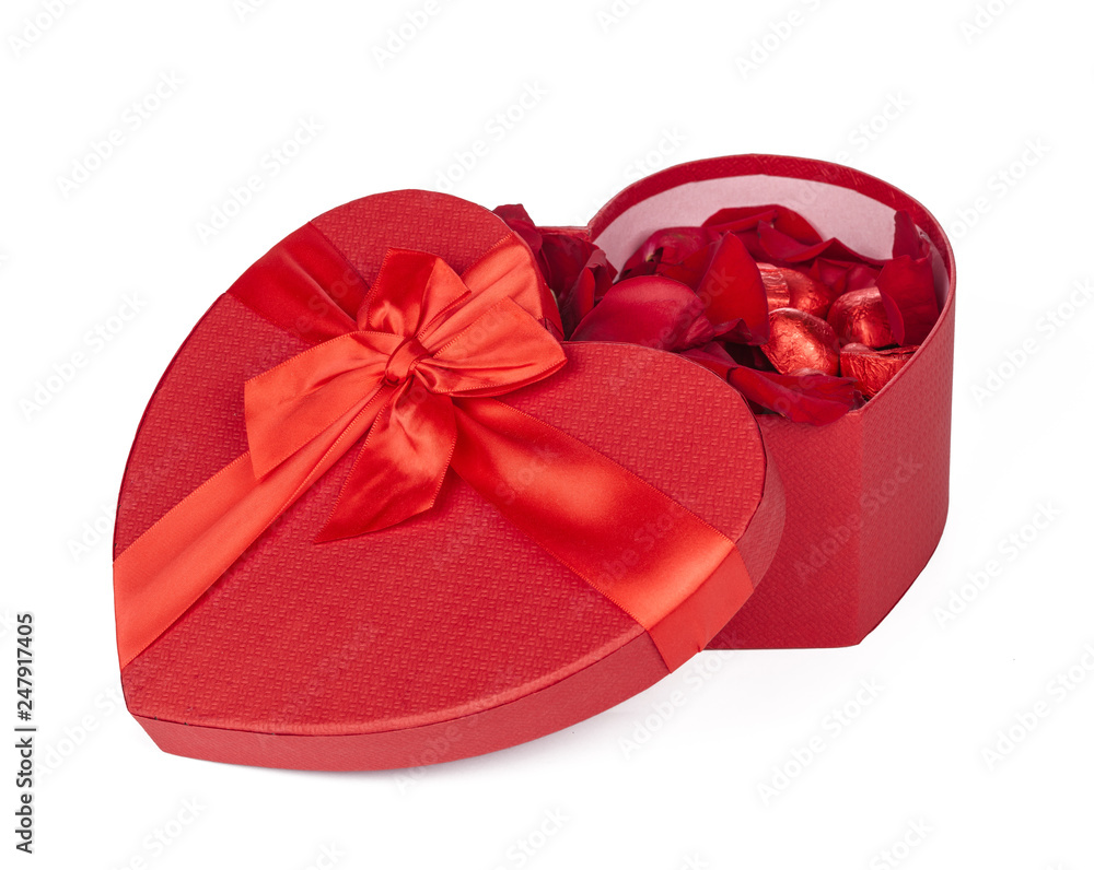 Many rose petals inside open gift box on old wooden background. Sweet holiday background with rose petals Many rose petals inside open gift box on old wooden background. Sweet holiday background with rose petals