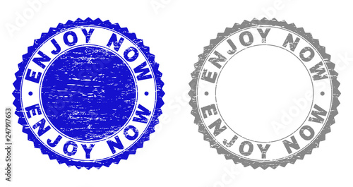 Grunge ENJOY NOW stamp seals isolated on a white background. Rosette seals with grunge texture in blue and gray colors. Vector rubber stamp imitation of ENJOY NOW title inside round rosette.