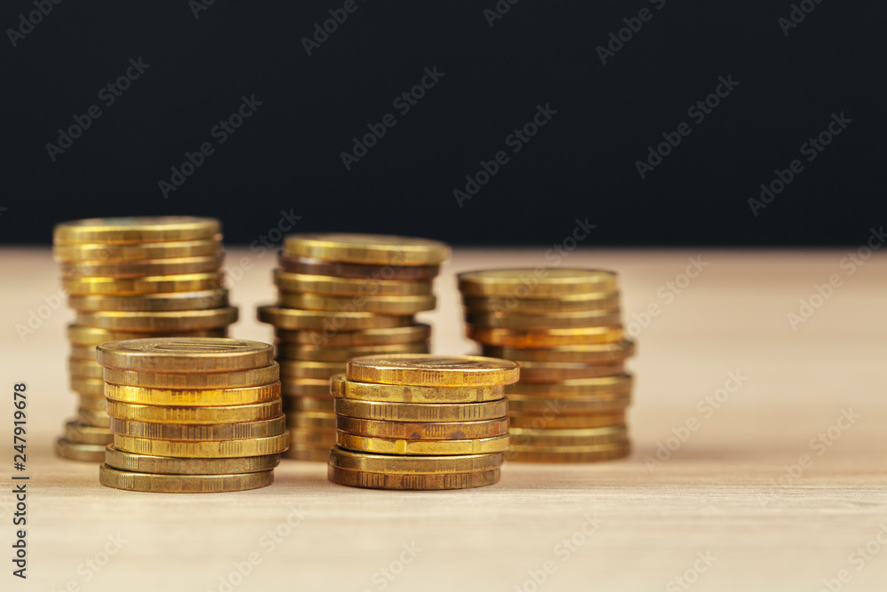 piles of coins on working table piles of coins on working table