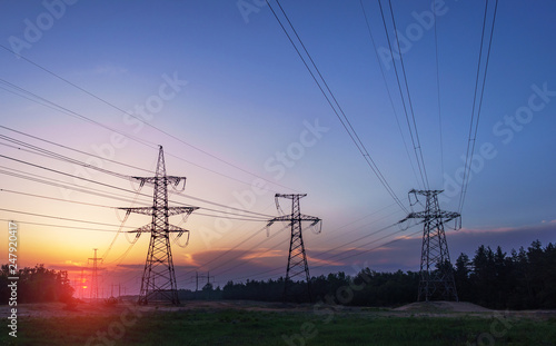 High-voltage power lines at sunset. electricity distribution station