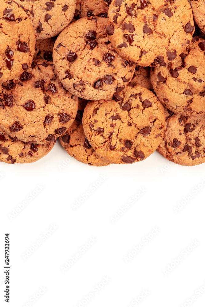 Many chocolate chip cookies, shot from above on a white background, an abstract sweet biscuits texture with copy space Many chocolate chip cookies, shot from above on a white background, an abstract sweet biscuits texture with copy space