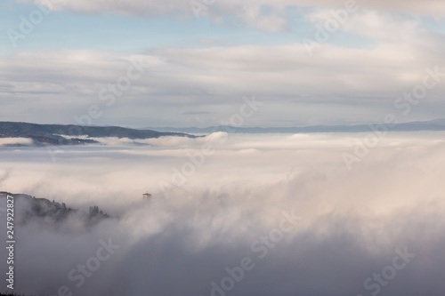 A view of St.Francis church in Assisi  Umbria  Italy  barely visible in the middle of fog