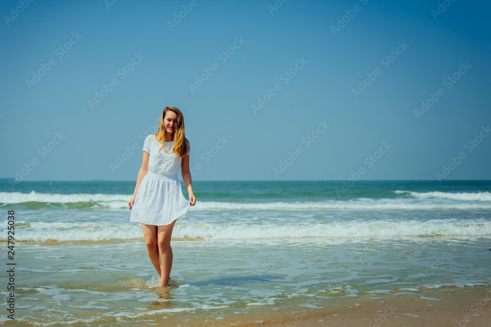 Beautiful Girl in White Dress Enjoy and Relax on The Beach. Travel and Vacation. Beautiful Girl in White Dress Enjoy and Relax on The Beach. Travel and Vacation.