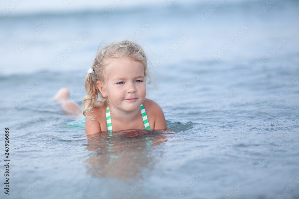 Little cute happy girl swims in the sea, Spain Little cute happy girl swims in the sea, Spain