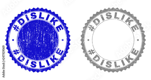 Grunge #DISLIKE stamp seals isolated on a white background. Rosette seals with distress texture in blue and grey colors. Vector rubber stamp imitation of #DISLIKE caption inside round rosette.