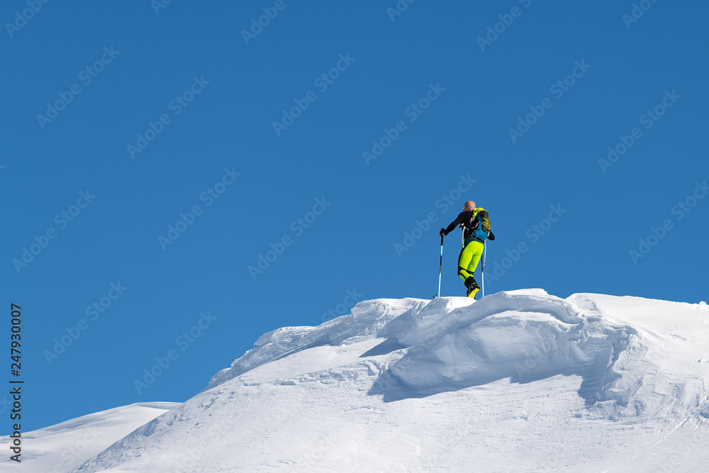 Climb with mountain skis and seal skins on a ridge