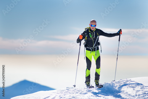 Mountaineer skier arriving at the summit