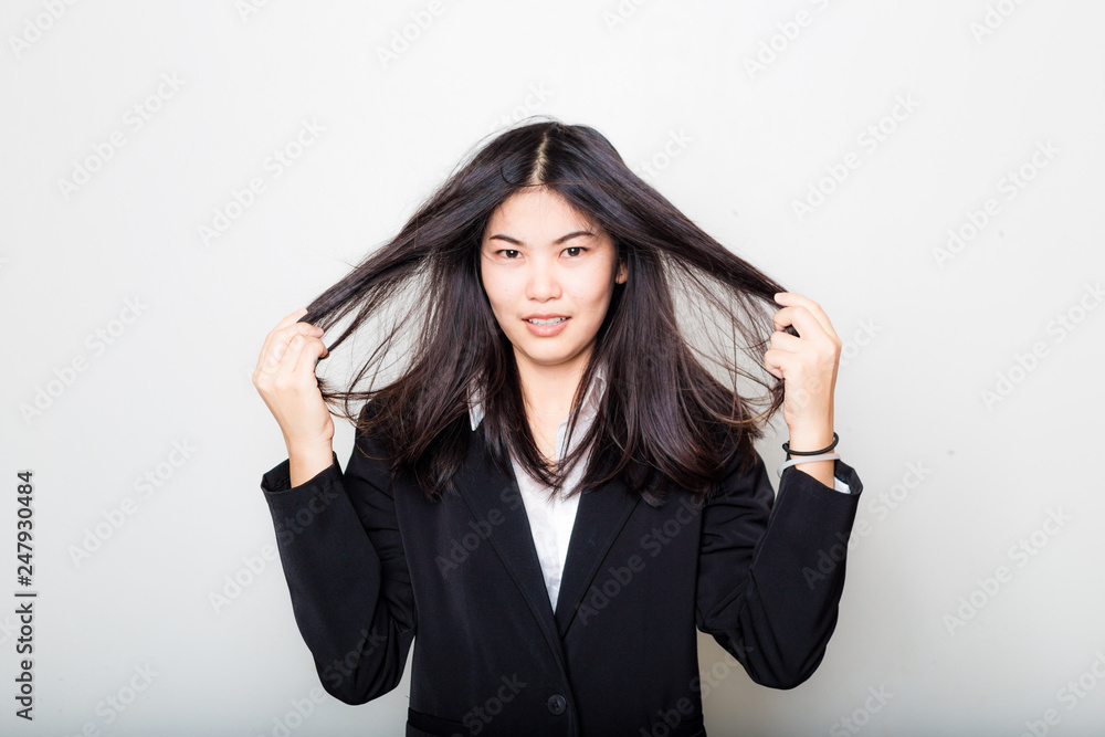 Business asian woman rubbing her hair feeling fatigue and headache afer work Business asian woman rubbing her hair feeling fatigue and headache afer work