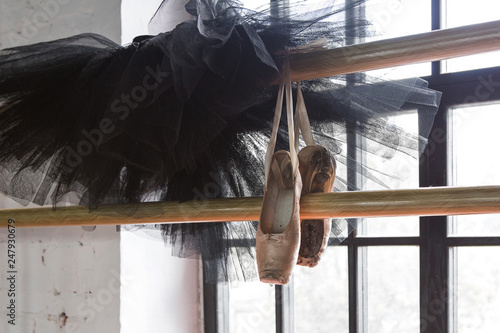 Ballet tutu and pointe shoes in a rehearsal background. Old pointe shoes.