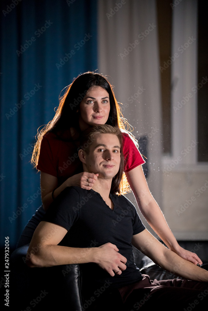 Young pretty couple sitting on a couch Young pretty couple sitting on a couch