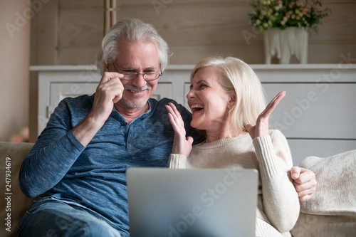 Εκτύπωση καμβά Spouses sitting on couch feels happy received great news online