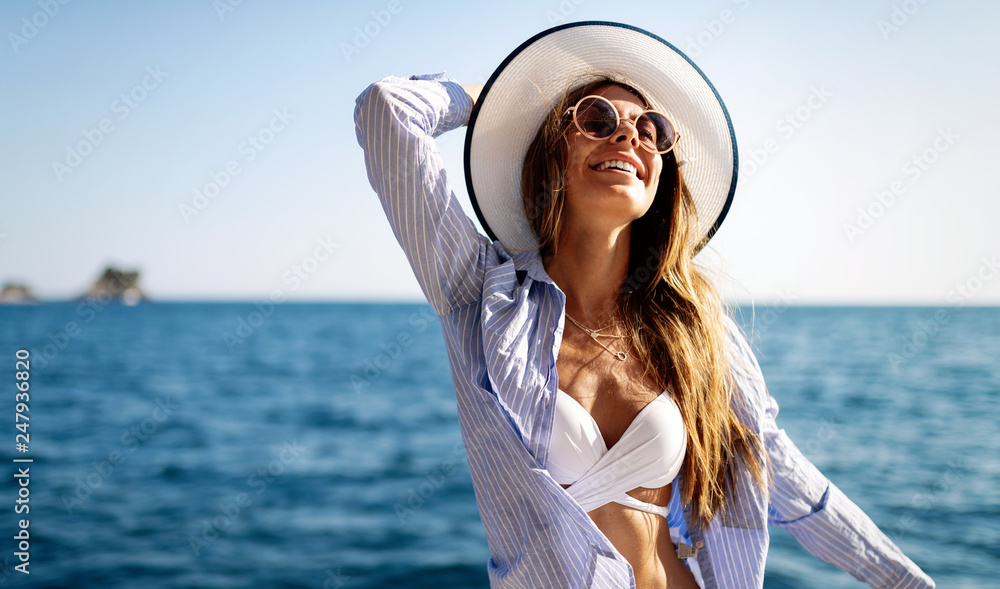 Young sexy woman in bikini enjoying summer vacation on beach - obrazy, fototapety, plakaty 