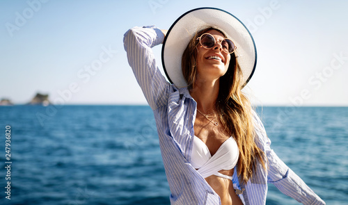 Young sexy woman in bikini enjoying summer vacation on beach