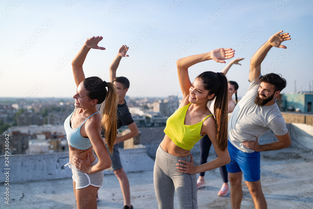 Group of happy fit friends exercising outdoor in city Group of happy fit friends exercising outdoor in city
