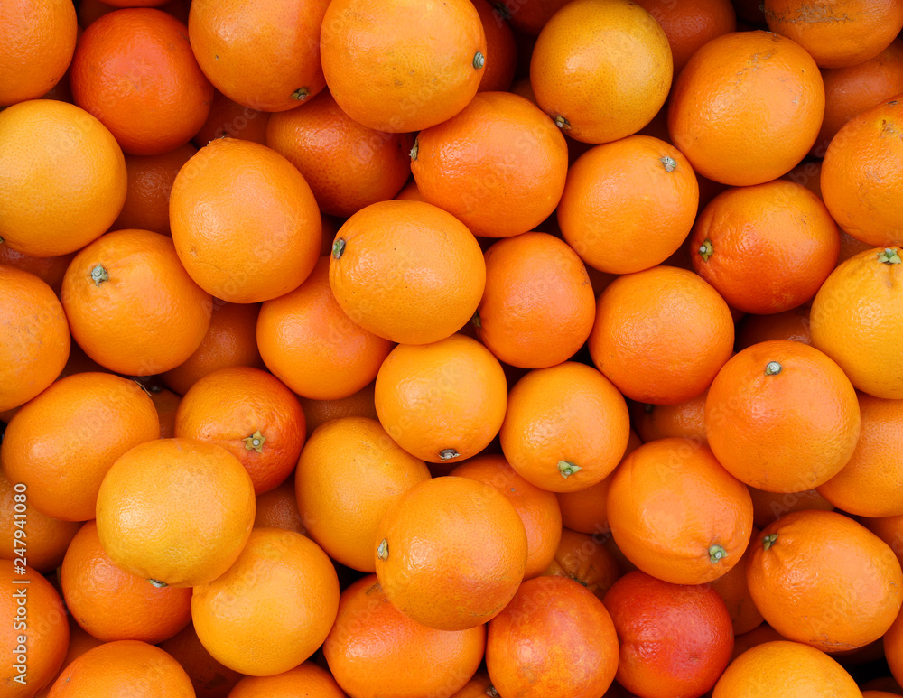 background of ripe oranges picked from the orchard tree