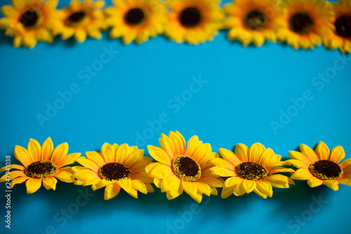 Artificial sunflowers of blue background with copy space