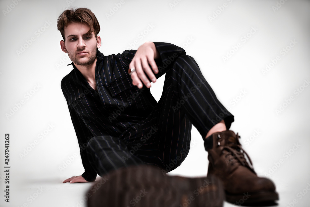 Young fashion men's model tests. Brutal guy model posing in black overalls  on a white background. Fashion photography in the studio Stock Photo |  Adobe Stock