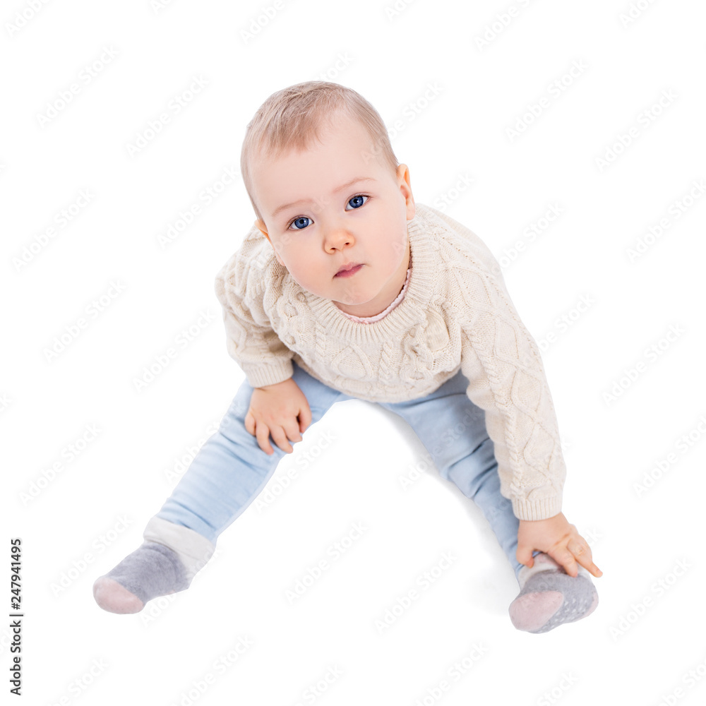 top view portrait of cute baby girl in winter clothes sitting isolated on white top view portrait of cute baby girl in winter clothes sitting isolated on white