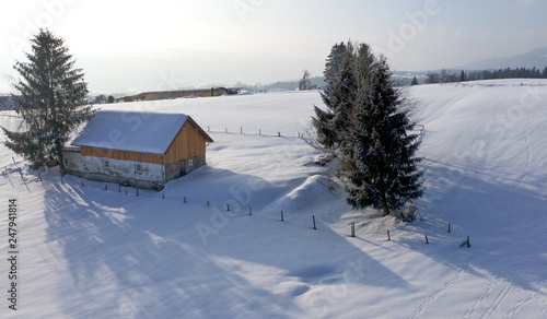 aerial flight over snow covered german village in winter © Andreas
