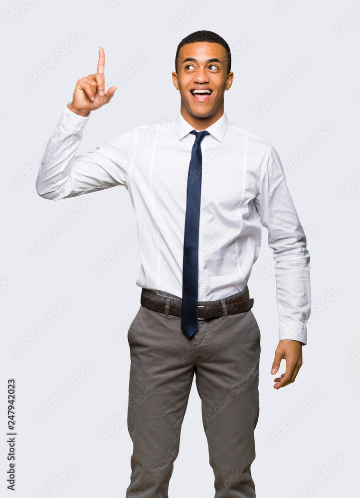 Young afro american businessman intending to realizes the solution while lifting a finger up on isolated background Young afro american businessman intending to realizes the solution while lifting a finger up on isolated background