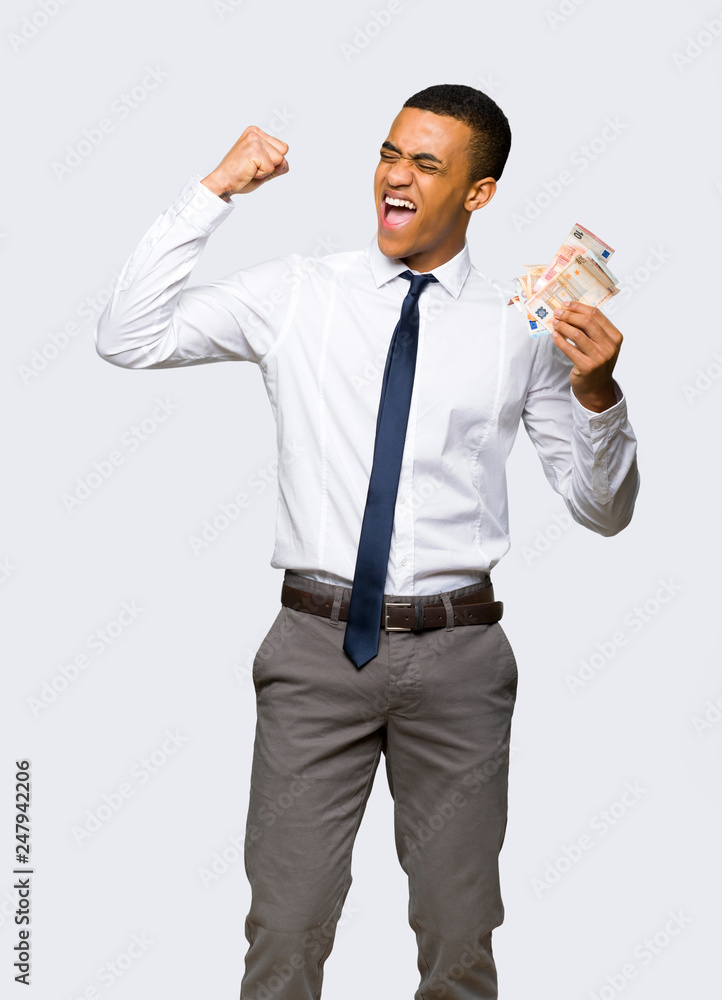 Young afro american businessman taking a lot of money on isolated background Young afro american businessman taking a lot of money on isolated background