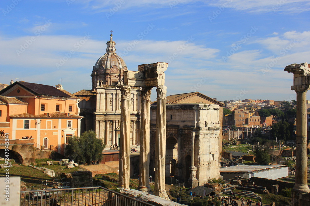 Ruins of Roman Forum. Temple of Vespasian and Titus, Arch of Septimius Severus and church of Santi Luca e Martina in Rome. Italy