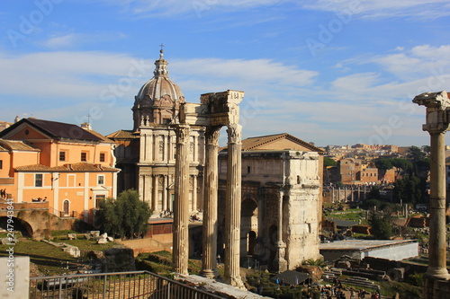 Ruins of Roman Forum. Temple of Vespasian and Titus, Arch of Septimius Severus and church of Santi Luca e Martina in Rome. Italy